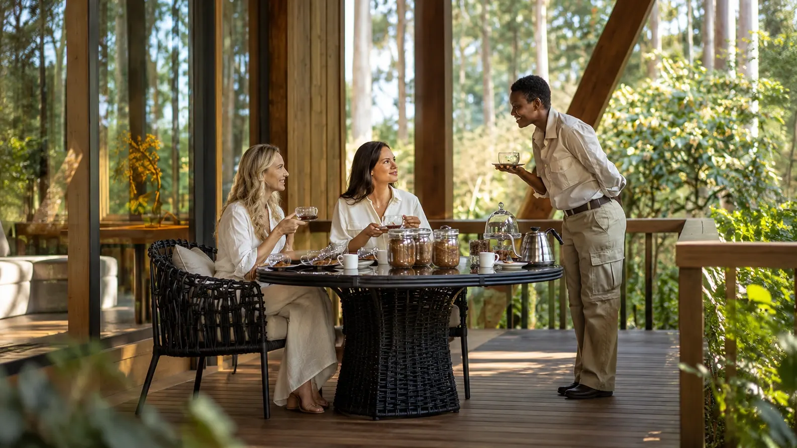 Guests being served tea on a forest lodge terrace in Rwanda